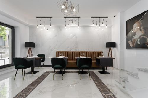 a dining room with a table and chairs at The Square Hotel in Cluj-Napoca