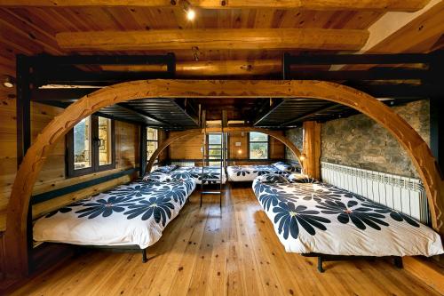 a room with a row of beds in it at CASA Guardafuentes de Ordesa in Buerba