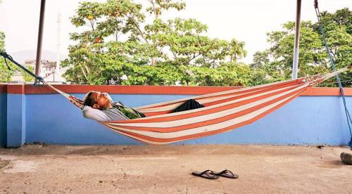 a man is laying in a hammock at Zumag Sisa in Tena