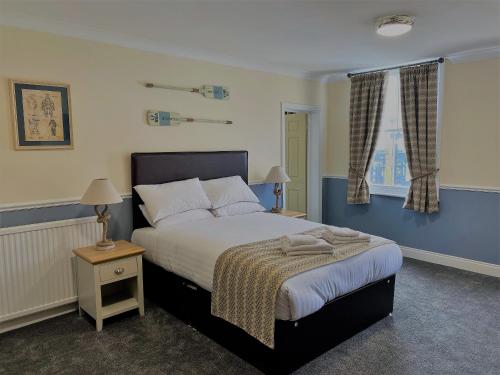 a bedroom with a large bed and a window at Katch in Northallerton
