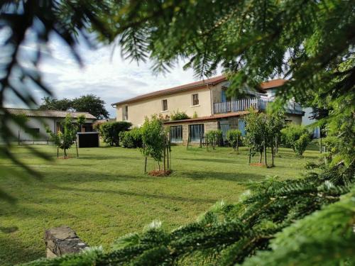 a house with a yard with trees in front of it at Revigora in Vienne