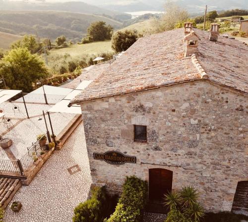 an old stone building with a sign on it at Agriturismo San Bartolomeo in Montecchio