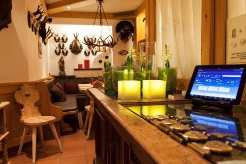 a kitchen with a counter with a laptop on it at Am Dorfplatz Suites - Adults friendly in Sankt Anton am Arlberg