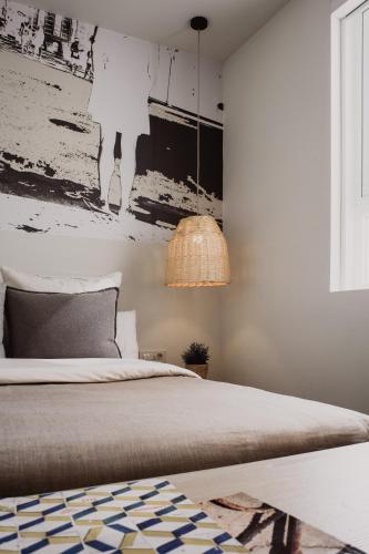 a bedroom with a bed and a painting on the wall at Select Sol in Madrid