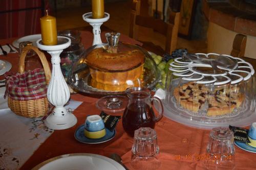 a table with a cake and other food on it at Villa Dacia in Guiglia