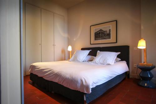 a bedroom with a large bed with white sheets and pillows at Les Chambres d'Andrea in Marseillan