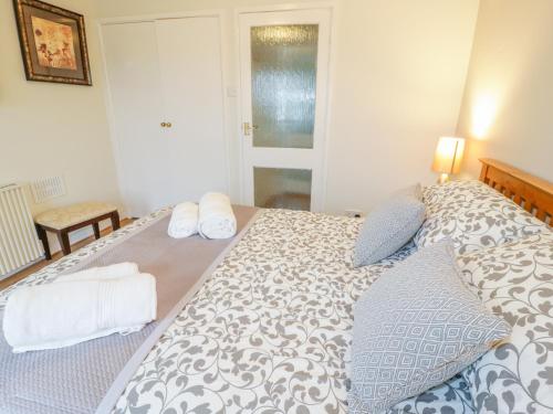a bedroom with a large bed with two pillows at Bwthyn in Moelfre