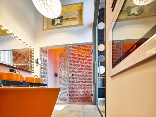 a lobby with a red brick wall and a glass door at Jaz in the City Amsterdam in Amsterdam