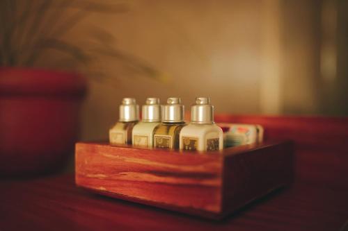 four bottles of essential oils sitting on a wooden box at Abracadabra Boutique Hotel in Búzios