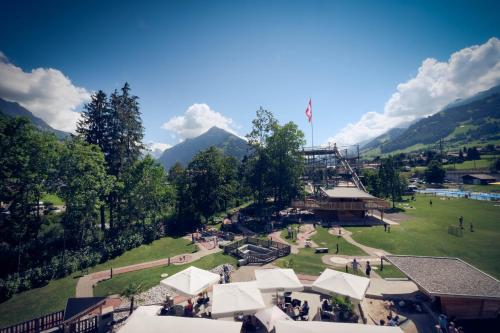 an aerial view of a park with mountains in the background at Frutigresort in Frutigen