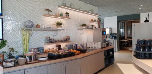a kitchen with a counter with food on it at ibis Budget Le Treport Mers Les Bains in Mers-les-Bains