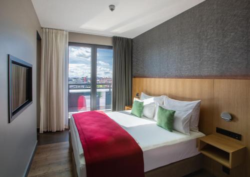 a hotel room with a large bed and a window at Ocak Hotel in Berlin