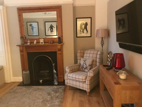 a living room with a chair and a fireplace at The Welford in Harrogate