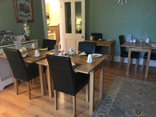 a dining room with a wooden table and chairs at The Welford in Harrogate