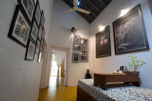 a room with a bed and pictures on the wall at Craft Hostels in Anjuna