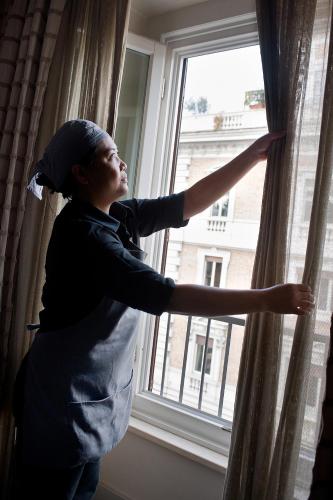 a man is looking out of a window at Casa Montani in Rome