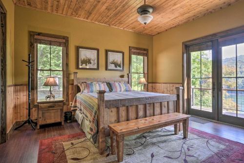 a bedroom with a bed and a wooden ceiling at Lakefront Norris Lake Cabin with Decks and Dock! in New Tazewell