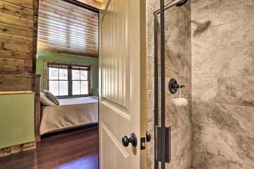 a bathroom with a walk in shower next to a bedroom at Lakefront Norris Lake Cabin with Decks and Dock! in New Tazewell