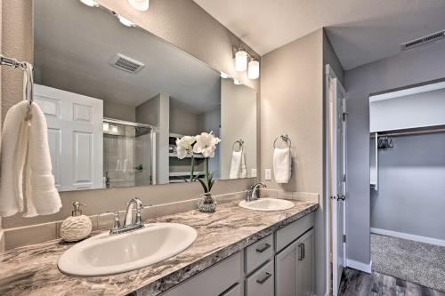 a bathroom with two sinks and a large mirror at Modern Caldwell House with Yard and Furnished Patio! in Caldwell