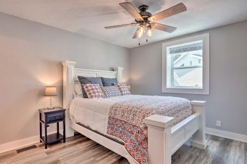 a bedroom with a bed with a ceiling fan at Private Boat Dock and Deck Lakefront Home! in Lake Ozark