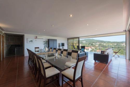 a dining room with a long table and chairs at LovelyStay - Casa Guimas in Penafiel