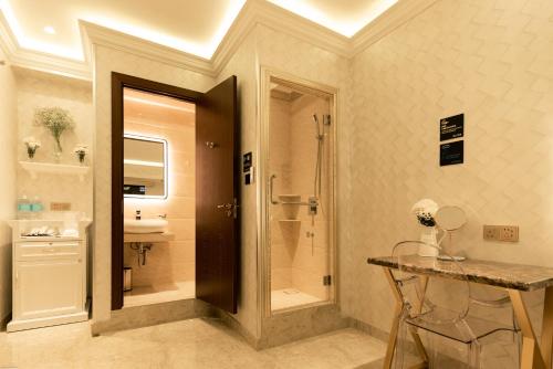 a bathroom with a walk in shower and a sink at AJ Residence - Above Peppermint Asia City in Kota Kinabalu