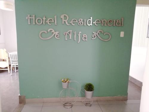 a sign for a hotel restaurant and alfa restaurant at Hotel Residencial Alfa in Lima