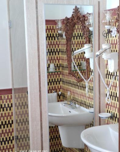 a bathroom with a sink and a mirror at Taverna Del Capitano in Massa Lubrense