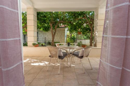 a patio with a table and chairs on a patio at Historic center Hvar town- a few steps from the main square in Hvar