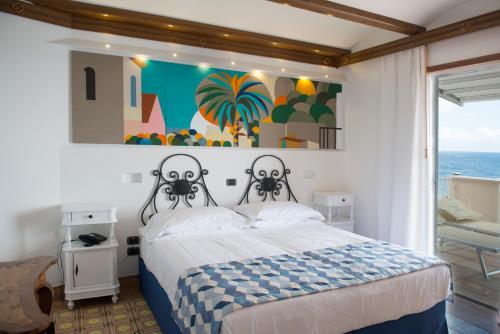 a bedroom with a bed and a painting on the wall at Taverna Del Capitano in Massa Lubrense