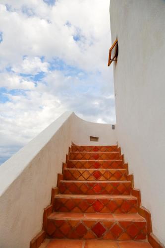 a flight of stairs with a sky in the background at Tribu Todos Santos in Todos Santos