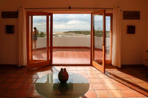 a room with a table and a view of the ocean at Tribu Todos Santos in Todos Santos
