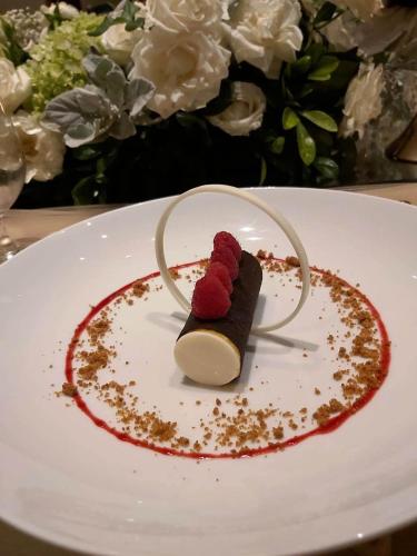 a dessert on a white plate with red sauce at Keliki Luxury Lodge in Ubud