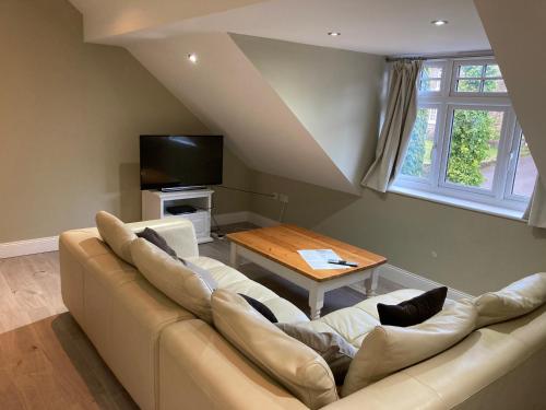 a living room with a couch and a table at White House Cottages in Durham