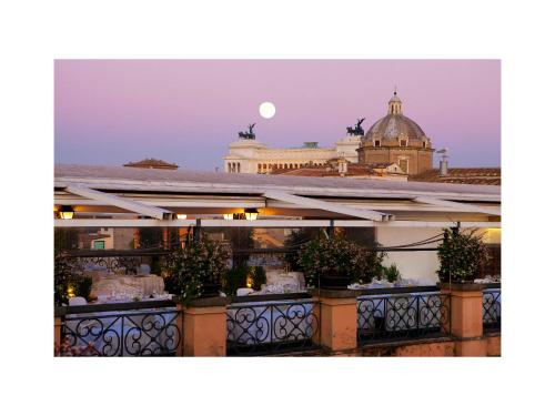 a large building with a clock on top of it at Grand Hotel De La Minerve in Rome