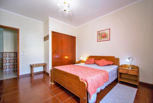 a bedroom with a bed and a dresser in it at Atlantico Sul in Quarteira