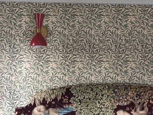 a wall with a blue and white wallpaper with a red lamp at Highlander Mountain House in Highlands