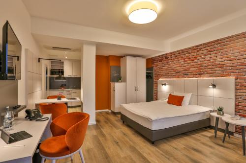 a bedroom with a bed and a brick wall at Boardinghouse Hirsch - Apartments in Kork in Kehl am Rhein
