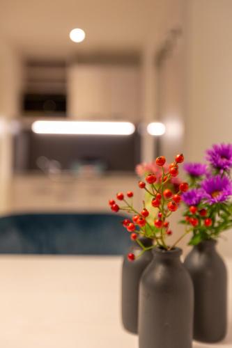 two vases filled with flowers on a table at Boardinghouse Hirsch - Apartments in Kork in Kehl am Rhein