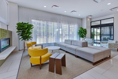 a living room with a couch and a table and chairs at Hotel Indigo Detroit Downtown, an IHG Hotel in Detroit