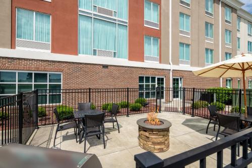 a patio with tables and chairs and an umbrella at Holiday Inn Express & Suites Florence by IHG in Florence