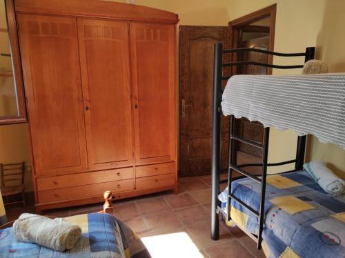 a bedroom with a bunk bed and a closet at LOS ABUELOS in Setenil
