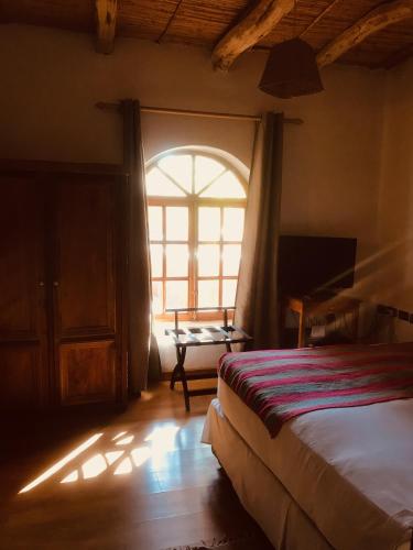 Una cama o camas en una habitación de Hotel La Aldea
