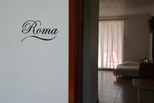a room with a sign that says roma on the wall at Hotel Boutique Casa Bella in Yautepec