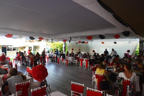 a group of people sitting at tables in a tent at Hotel Boutique Casa Bella in Yautepec