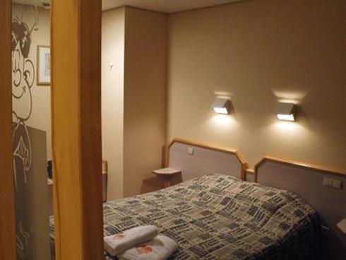 Een bed of bedden in een kamer bij Familiehotel Soll Cress Koksijde