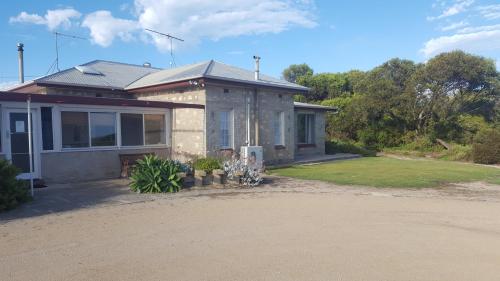 a small house with a driveway in front of it at Hillocks Drive in Marion Bay
