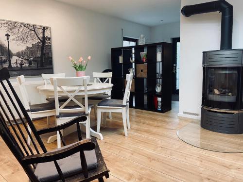 sala de estar con mesa y chimenea en Ferienwohnung Tulpenweg mit Kaminofen, en Haiger