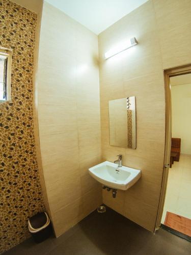 a bathroom with a sink and a mirror at Hotel Arcadia in Panaji