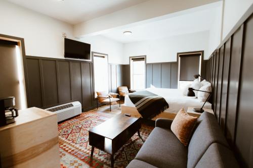a hotel room with a bed and a couch at The Flying Steamshovel Inn in Rossland
